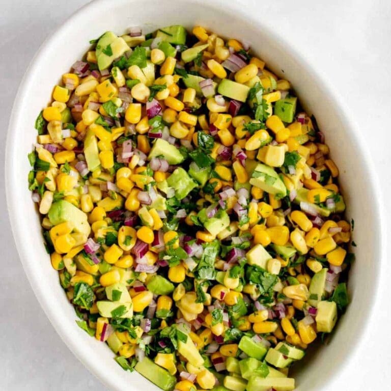 Avocado corn salsa in a white serving dish.