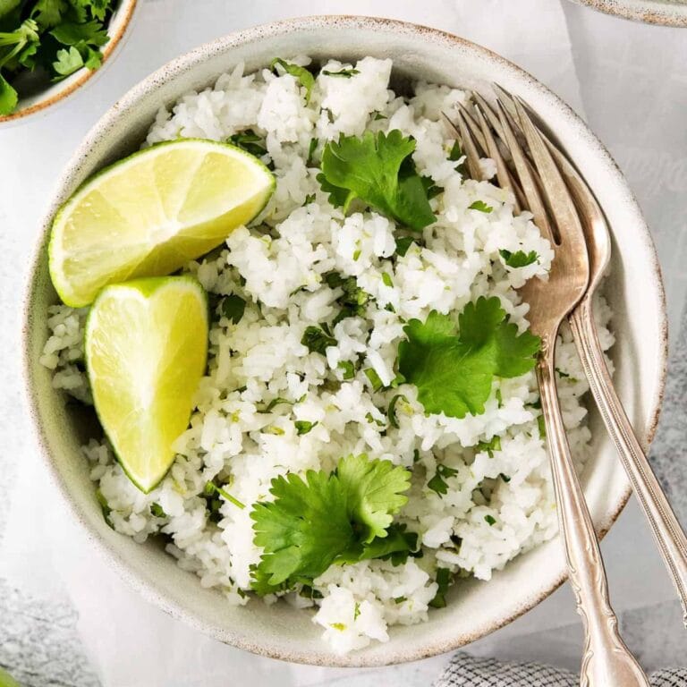 Bowl of cilantro lime rice with serving spoons.