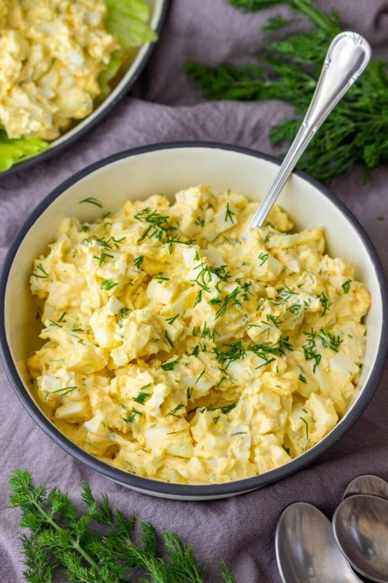 Egg salad with dill in a bowl with spoon.