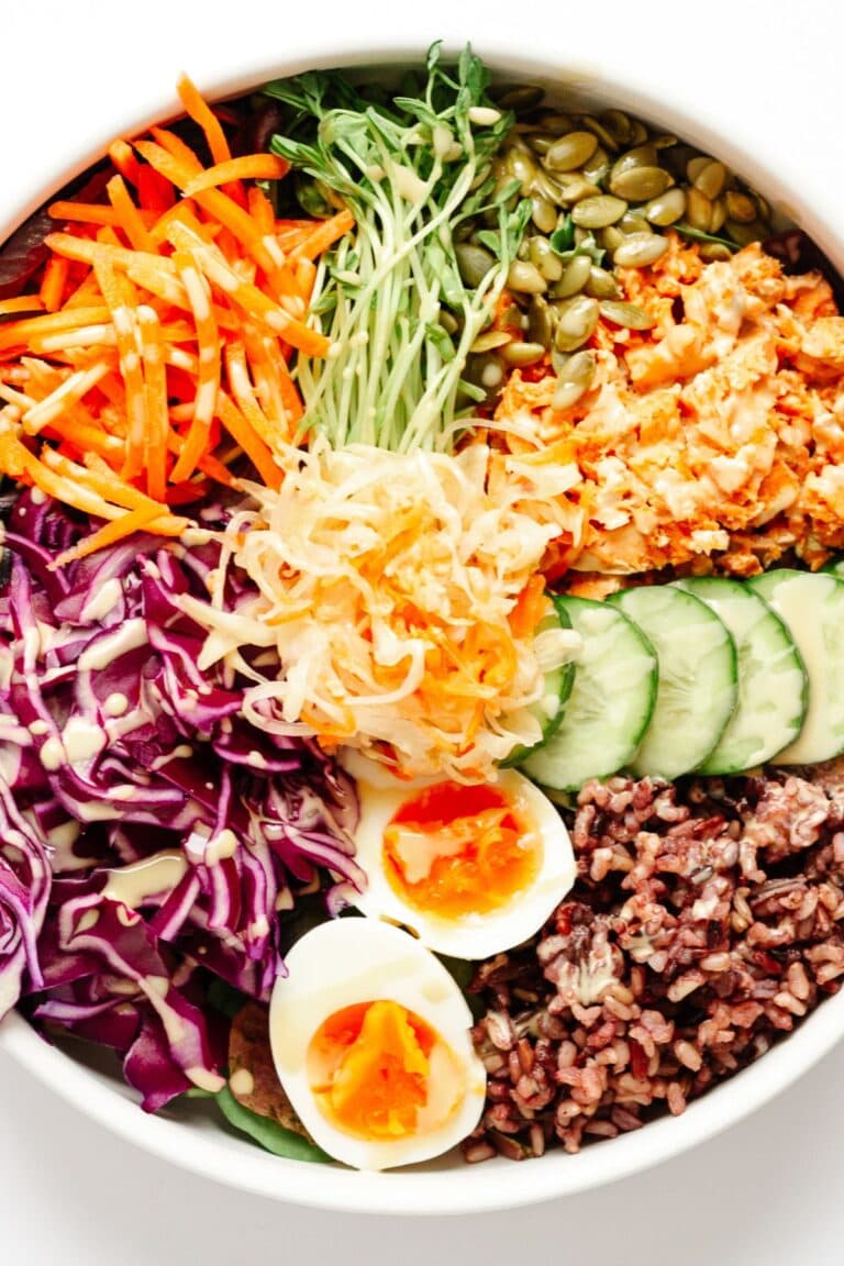 Nourish bowl with salmon, boiled egg, wild rice mix and a variety of veggies.