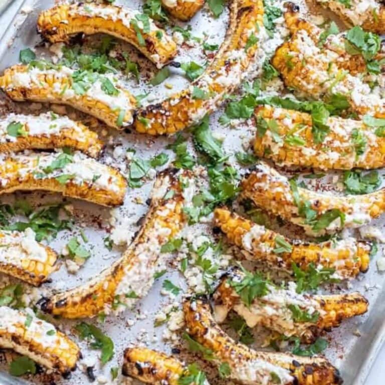 Mexican corn ribs on a baking sheet.
