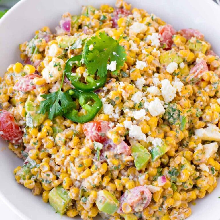 Mexican street corn salad in a white serving bowl.
