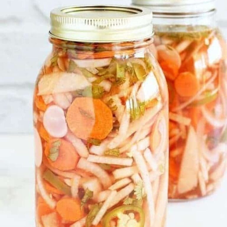 2 large mason jars of Mexican-style pickled vegetables.