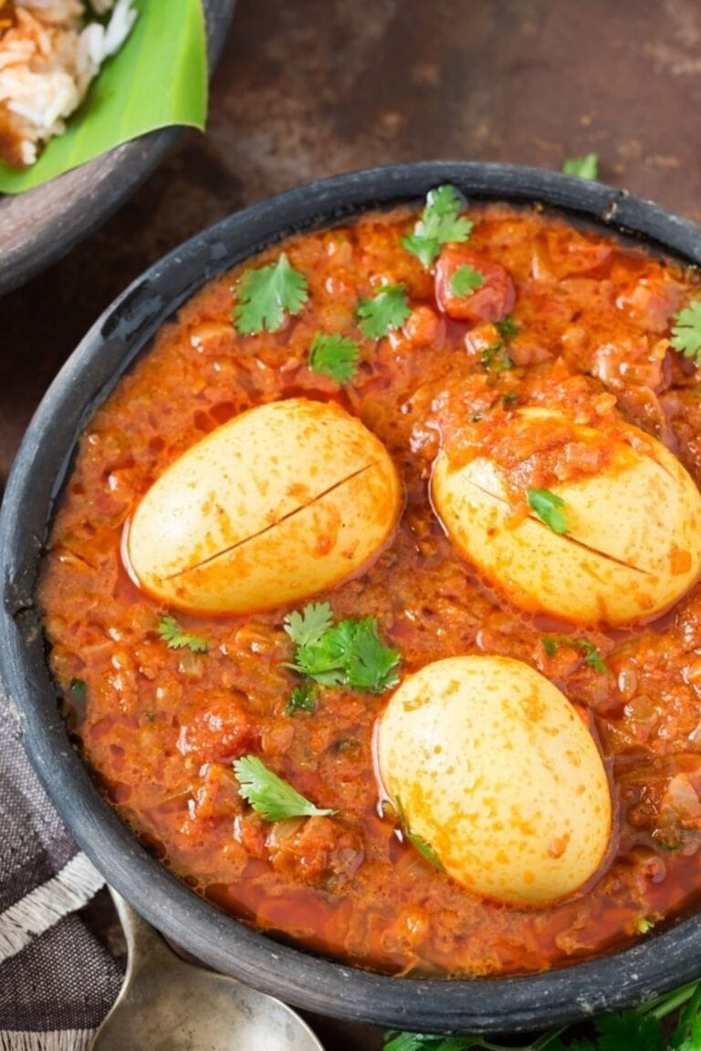 South Indian spicy egg curry in a black dish.