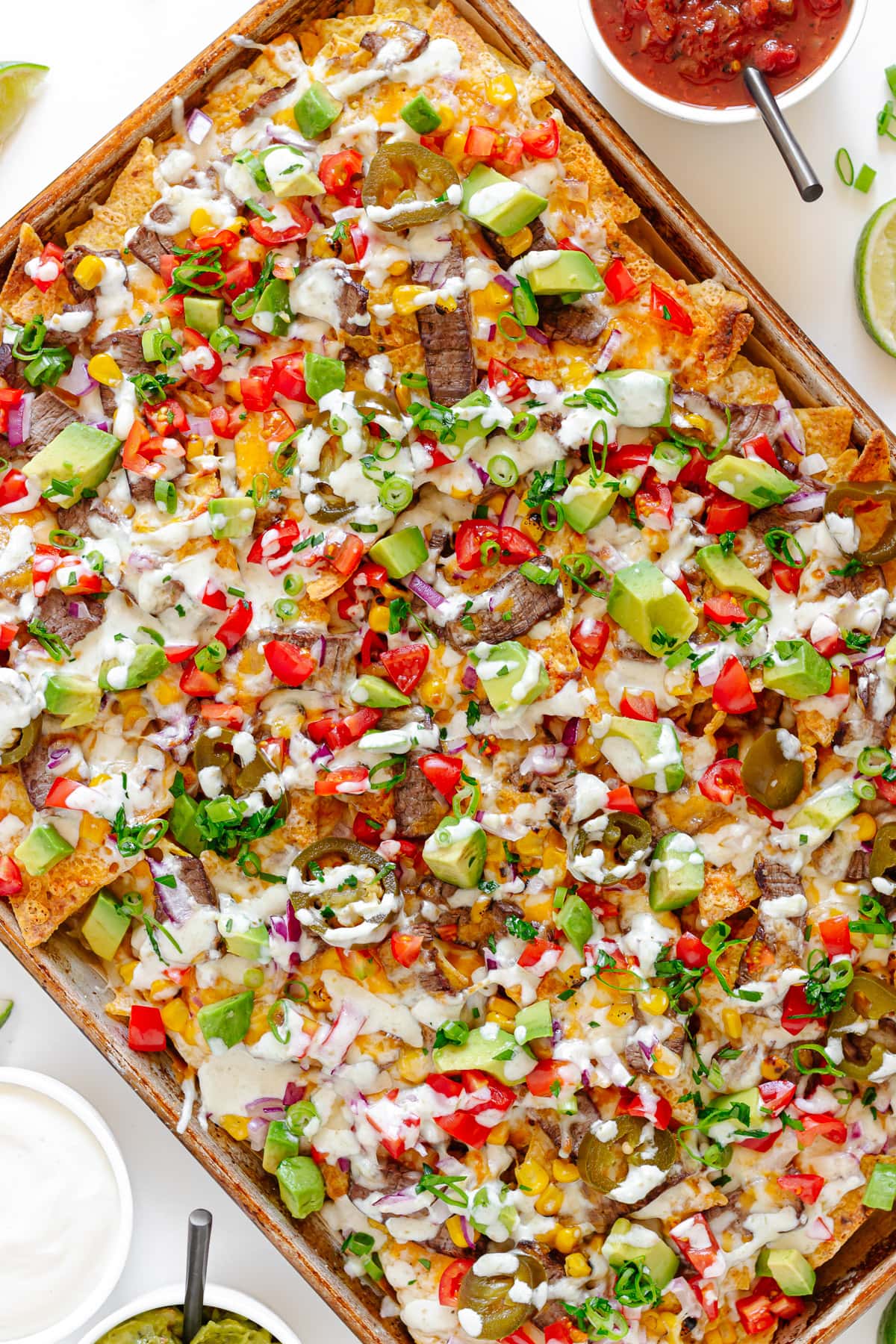 Leftover steak nachos on a sheet pan.