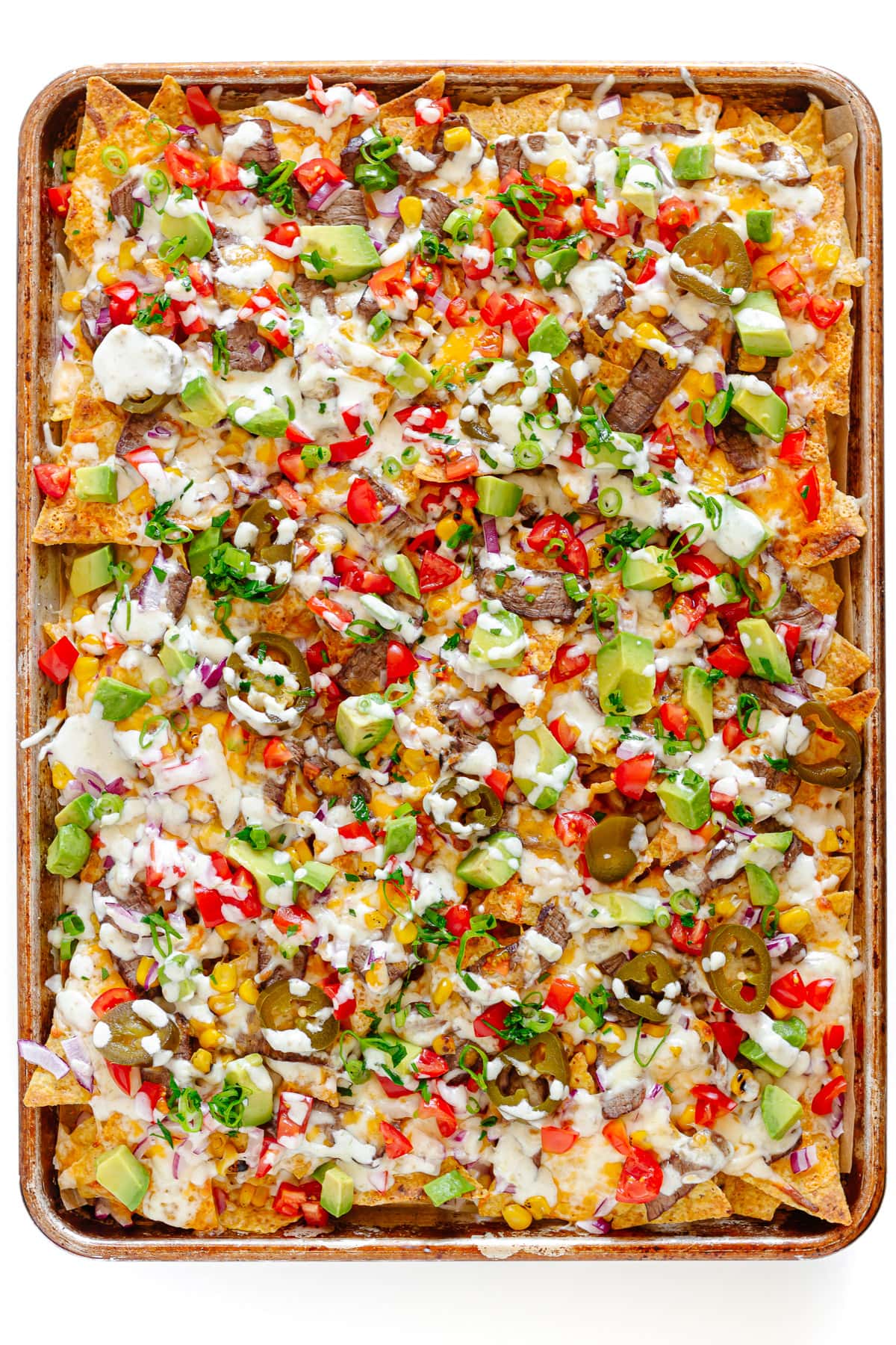 Steak nachos on a sheet pan.