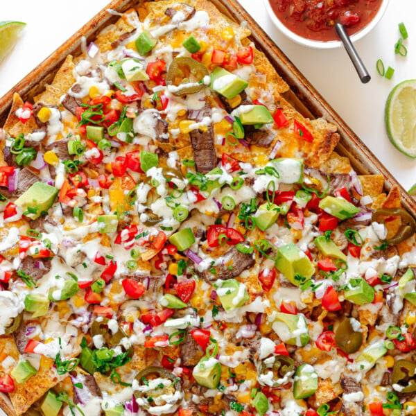 A sheet pan of loaded steak nachos.