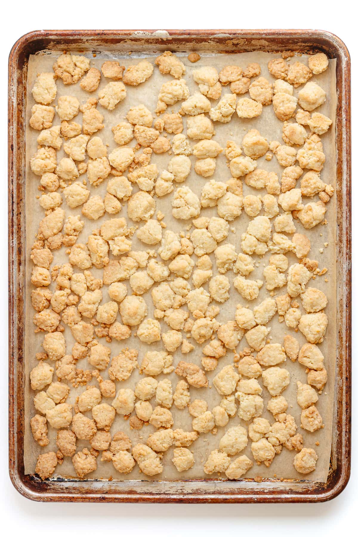 Baked streusel topping on a baking sheet.