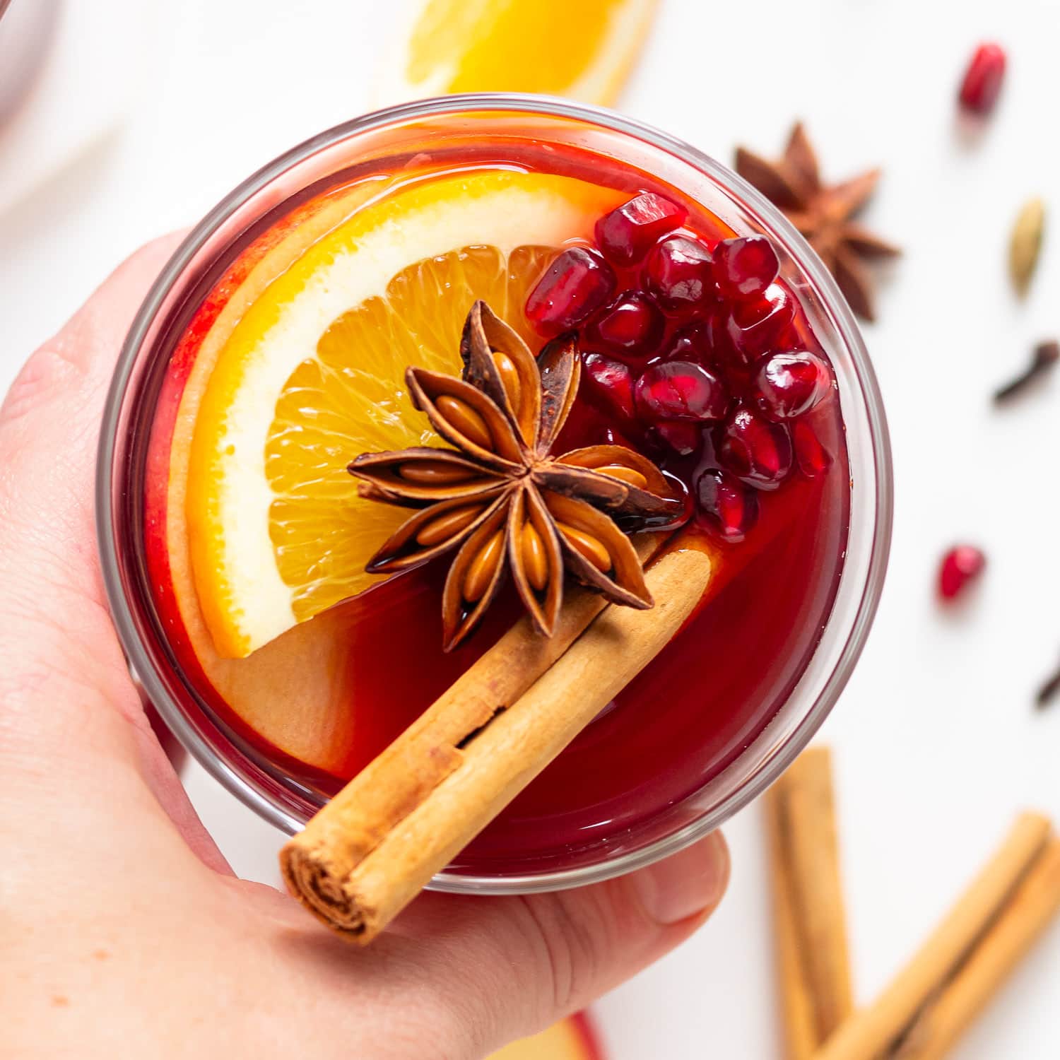 Hand holding a glass of Kinderpunsch (non alcoholic Christmas punch).