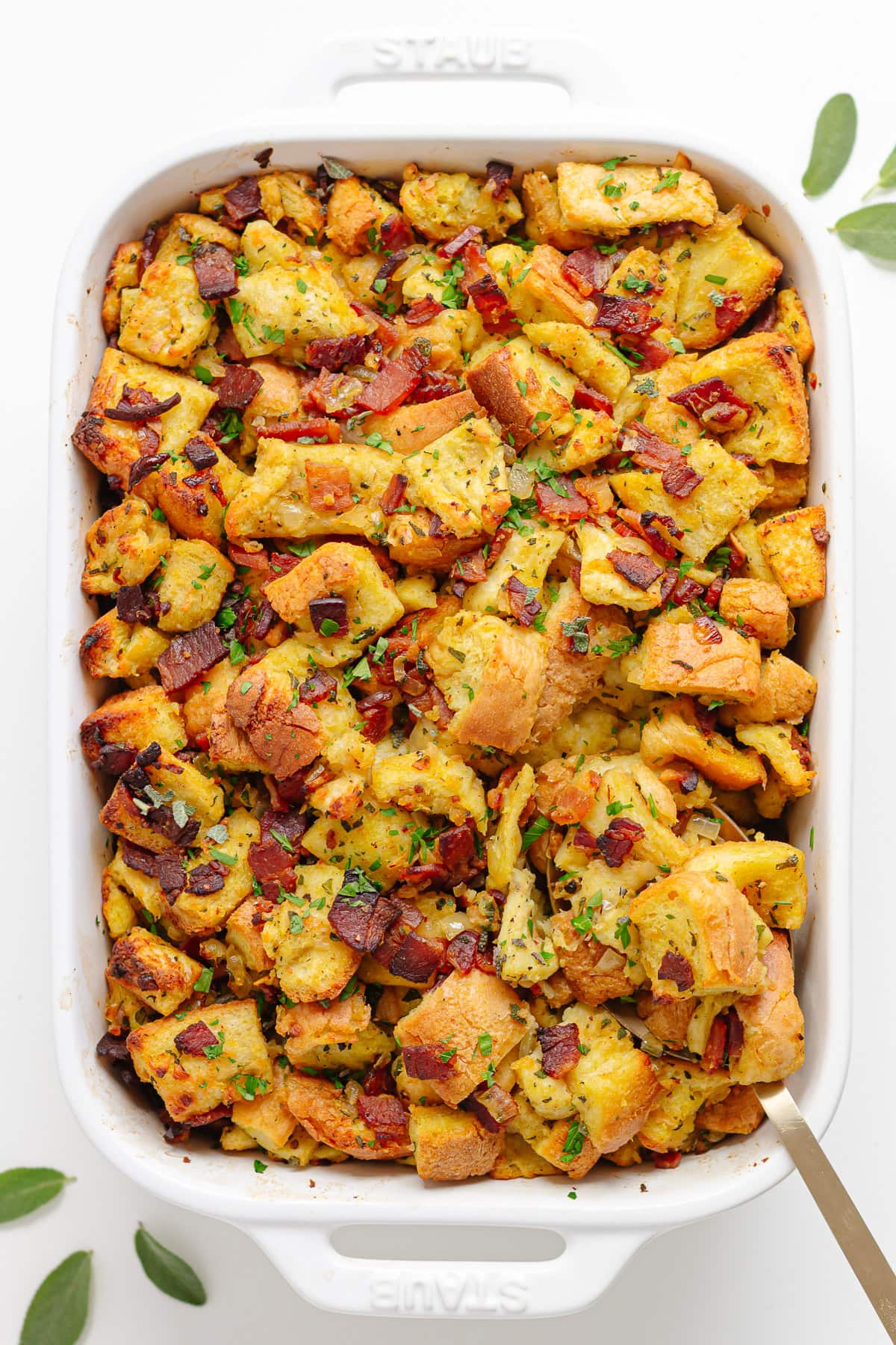 Homemade Thanksgiving stuffing in a white casserole dish.