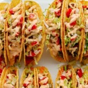 Casserole dish of cheeseburger tacos with text overlay that reads "Baked Cheeseburger Tacos".