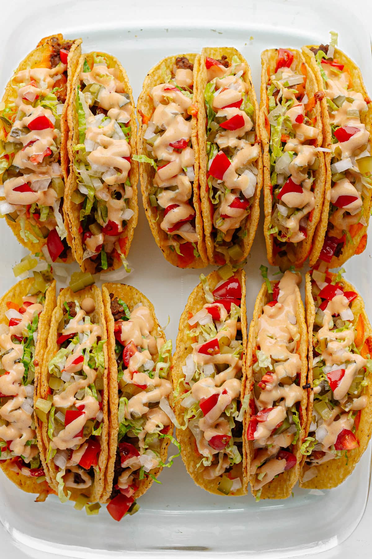 Glass casserole dish filled with cheeseburger tacos.