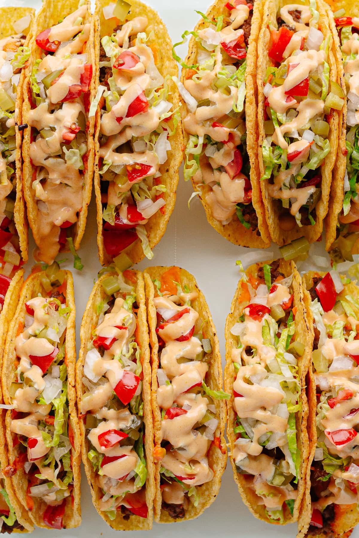 Glass dish of baked cheeseburger tacos.