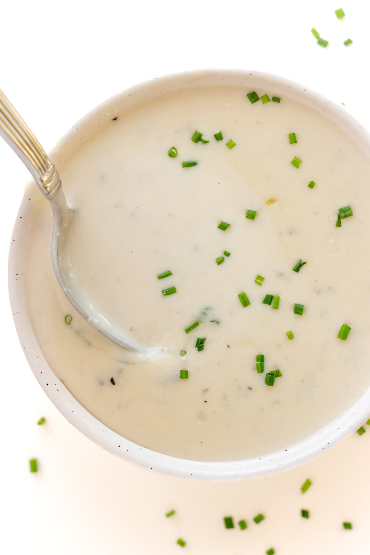 Bowl of gorgonzola cream sauce with a spoon.