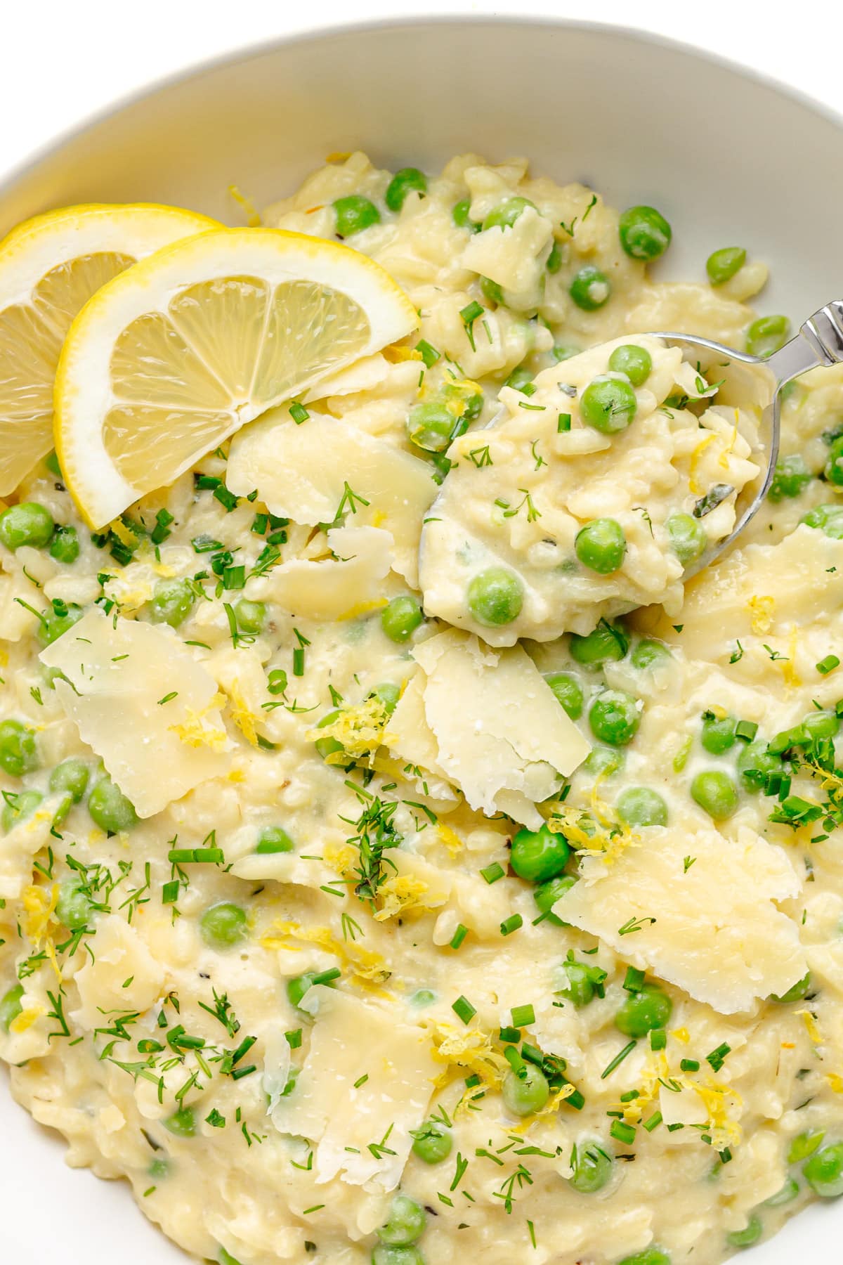 Creamy pea risotto in a white bowl.