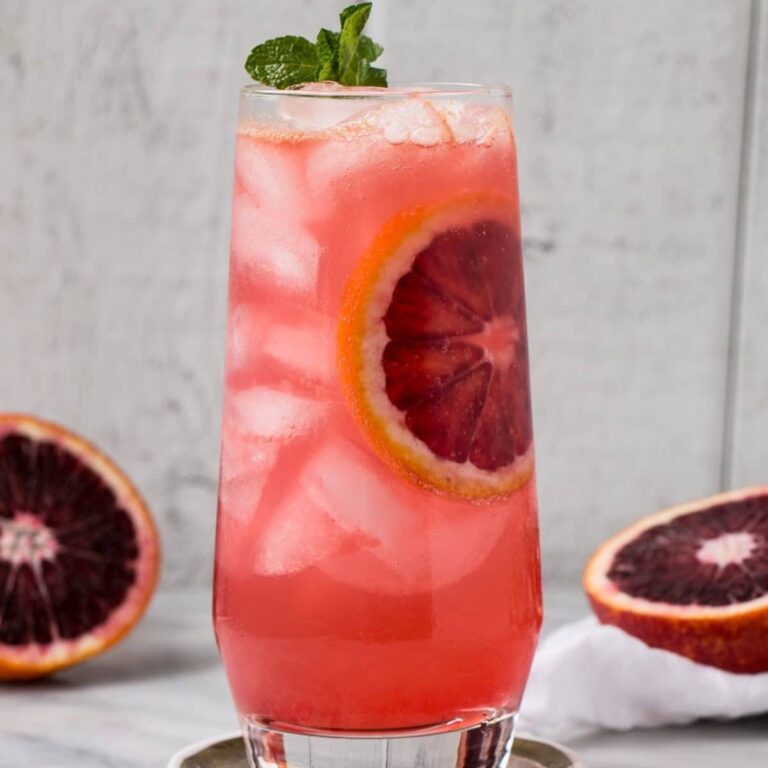 Blood orange gin and tonic in a tall glass.