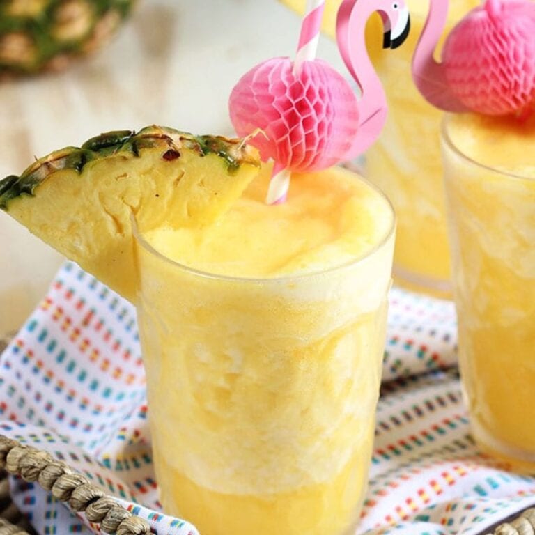 Pineapple prosecco wine slushies in glasses with flamingo straws.