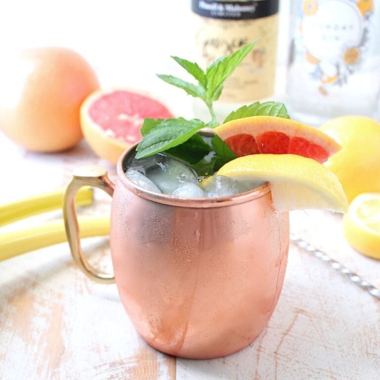 Sparkling grapefruit gin mule cocktail in a copper mug.