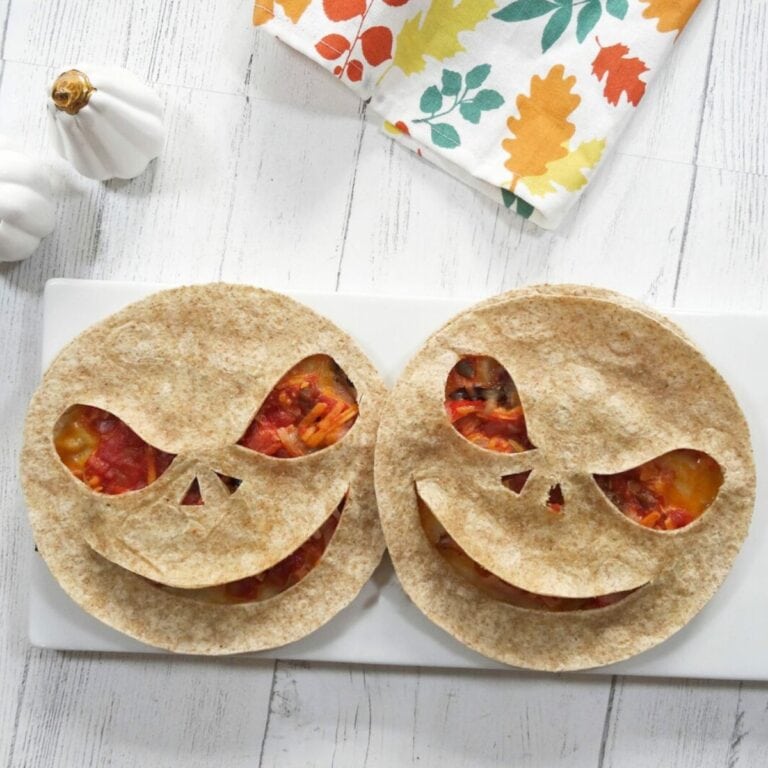 Two quesadillas with creepy faces cut into them for Halloween.