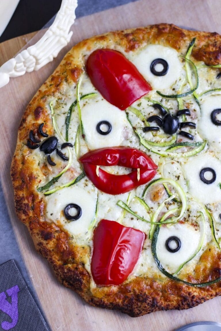 A Halloween themed pizza with spooky toppings.