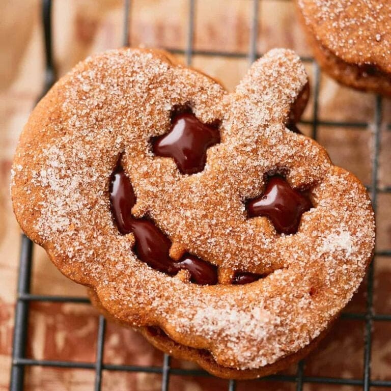 Pumpkin cookie filled with chocolate shaped to look like a jack-o'-lantern.