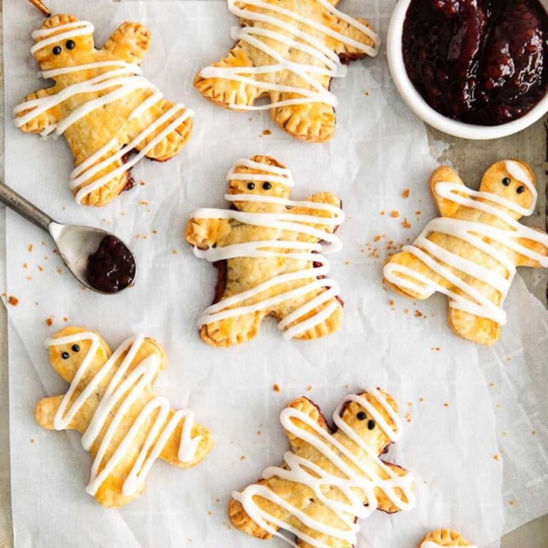 Mummy hand pies on parchment paper.