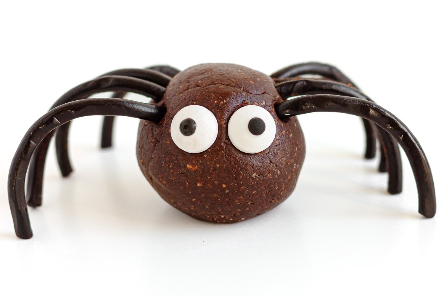 Closeup of a spider energy ball on a white surface.