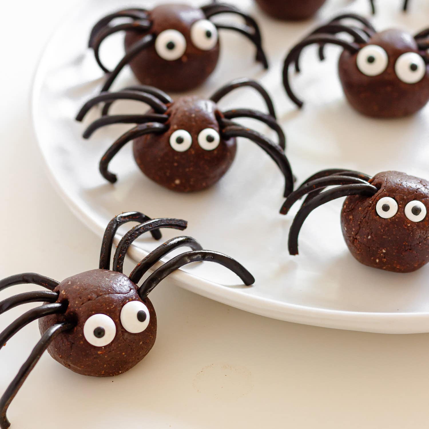 Spider energy bites on a white plate.