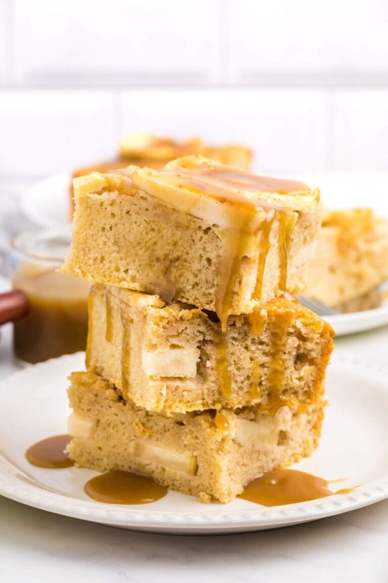 Three slices of apple sheet cake stacked on a white plate.
