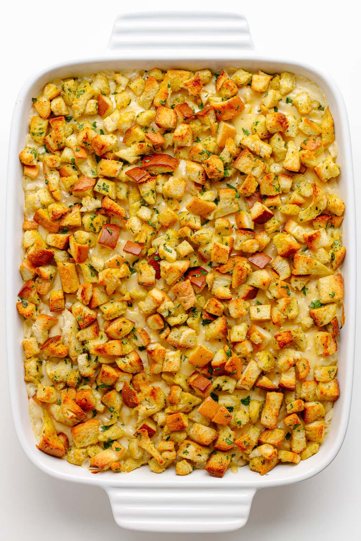 Baked gouda mac and cheese with buttery bread topping in a white casserole dish.