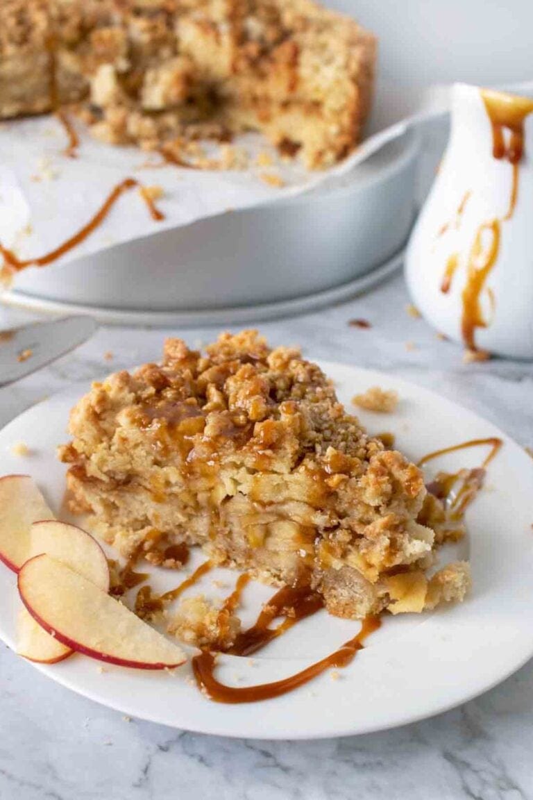Slice of caramel apple torte drizzled with dark caramel sauce.
