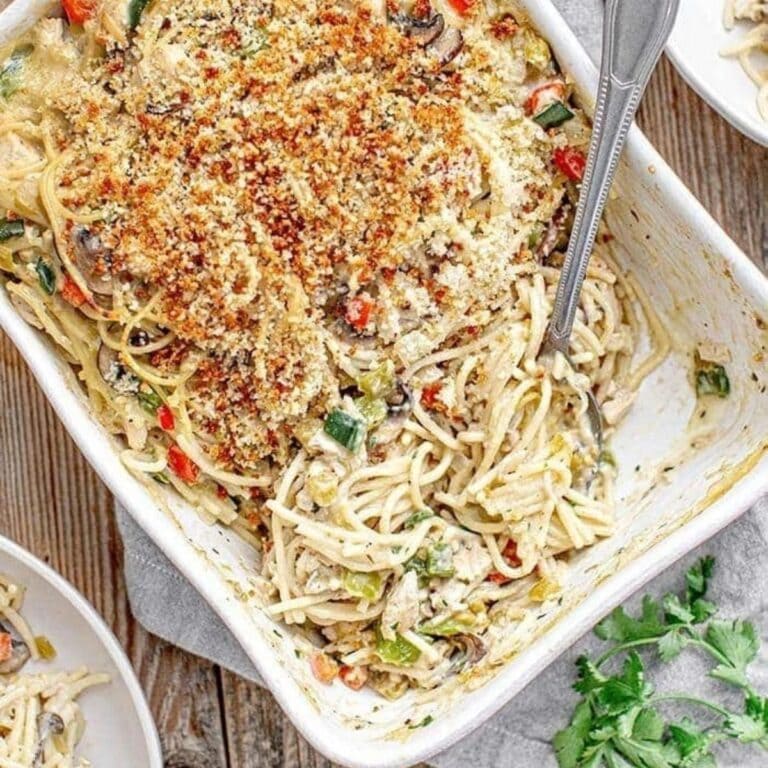 Green chili turkey tetrazzini in a white casserole dish.