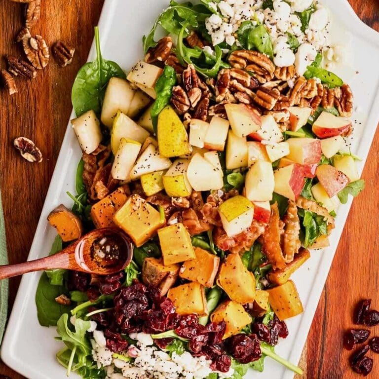 Harvest salad on a serving platter with poppy seed vinaigrette.