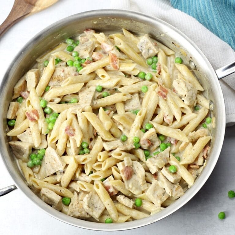 Turkey alfredo in a stainless steel skillet.