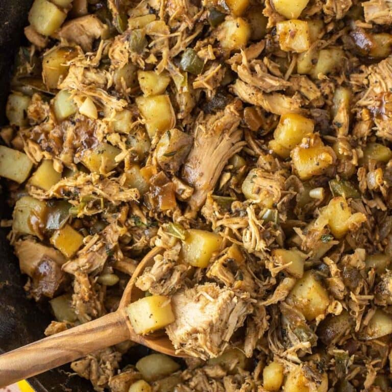 Closeup of leftover turkey hash with a wooden spoon.