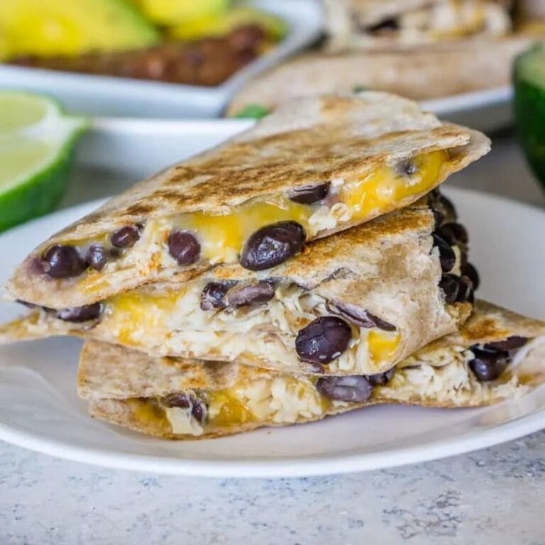 Turkey quesadillas with black beans piled on a plate.