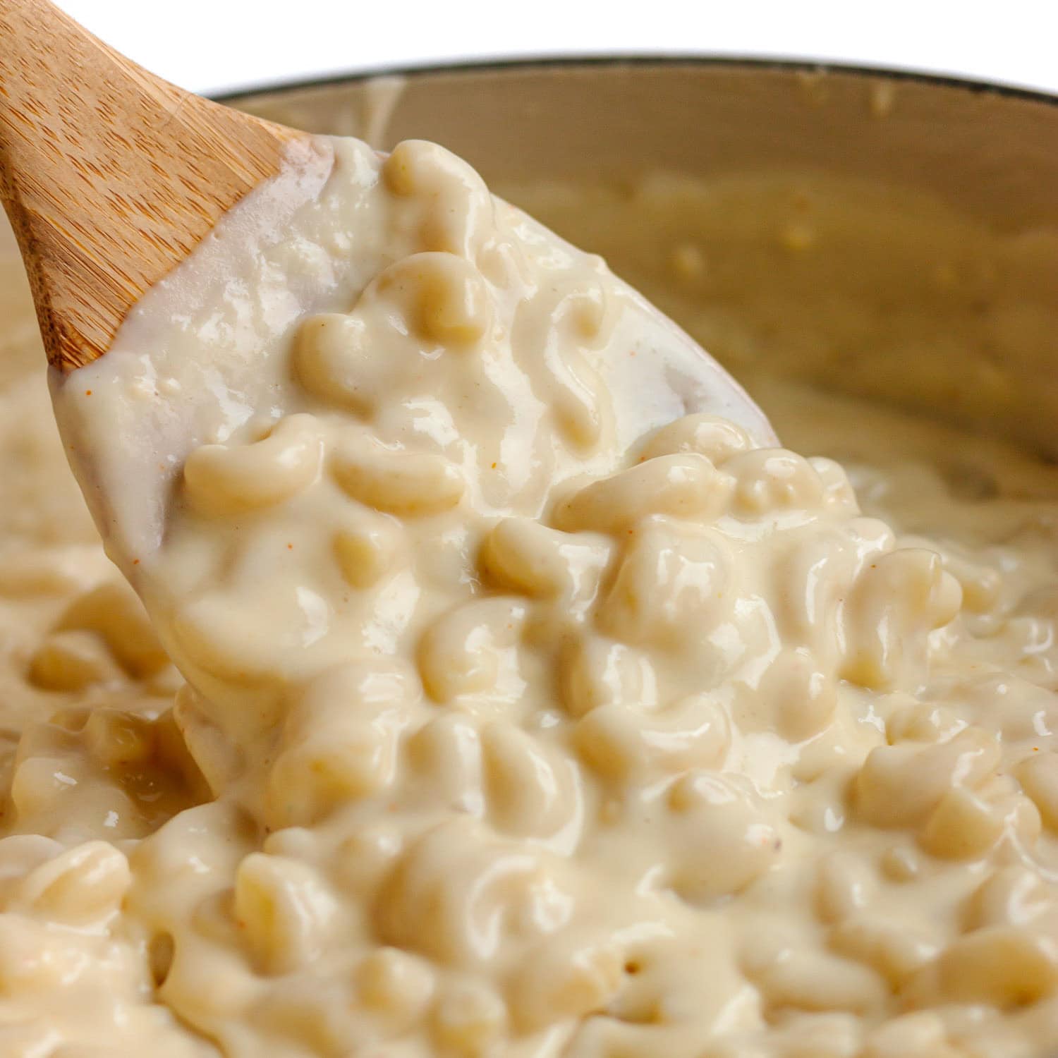 Stovetop gouda mac and cheese being stirred.