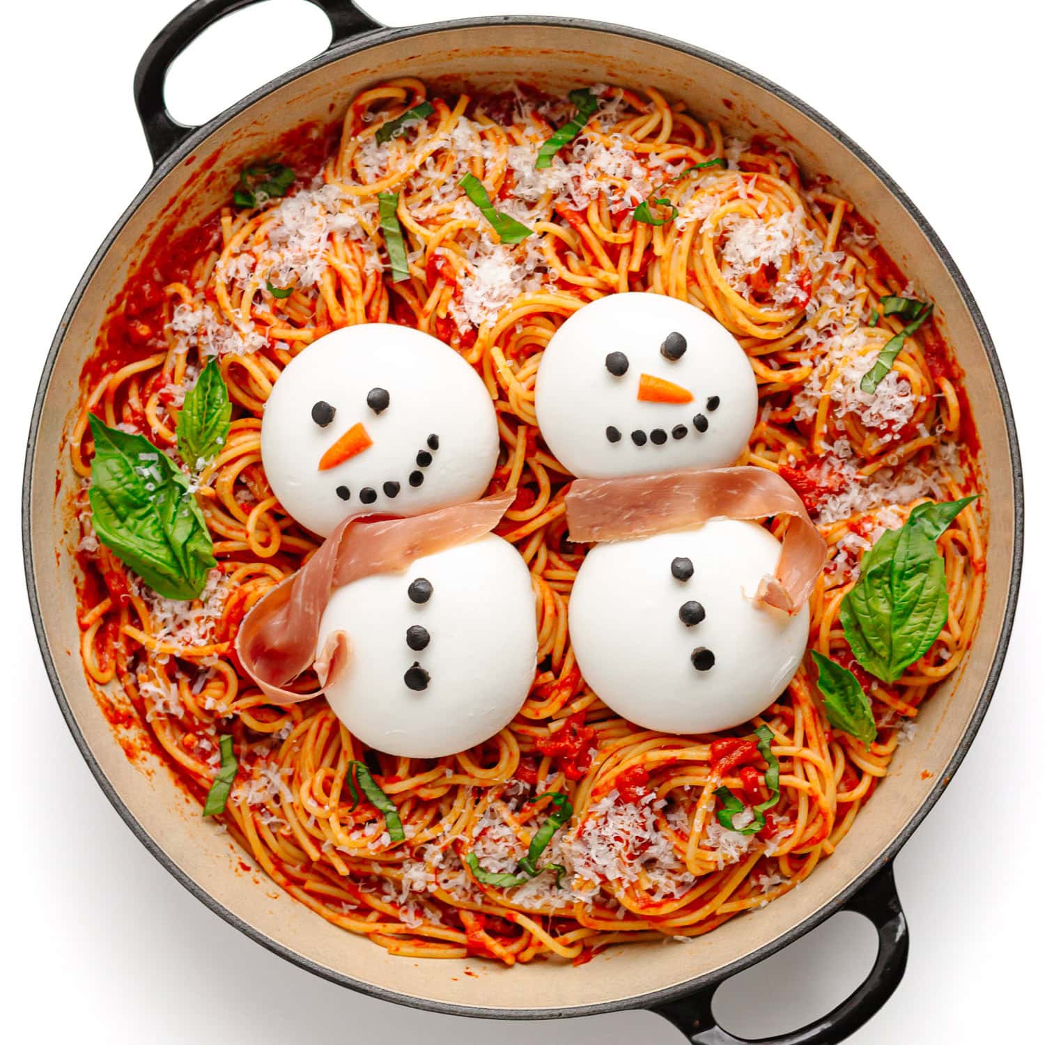 Christmas spaghetti with two burrata snowmen on top.