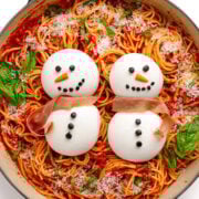 Christmas themed pasta topped with two burrata snowmen.