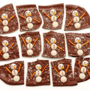 Snowman Christmas chocolate bark cut into pieces on a white background.