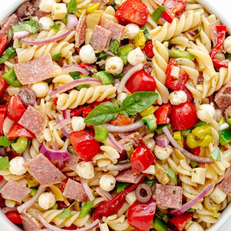 Antipasto pasta salad in a white serving bowl.