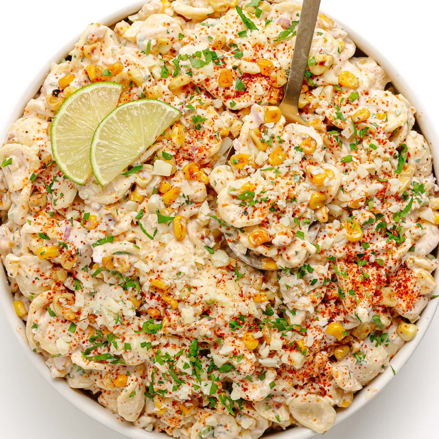 Serving bowl of elote pasta salad with creamy chili lime dressing.