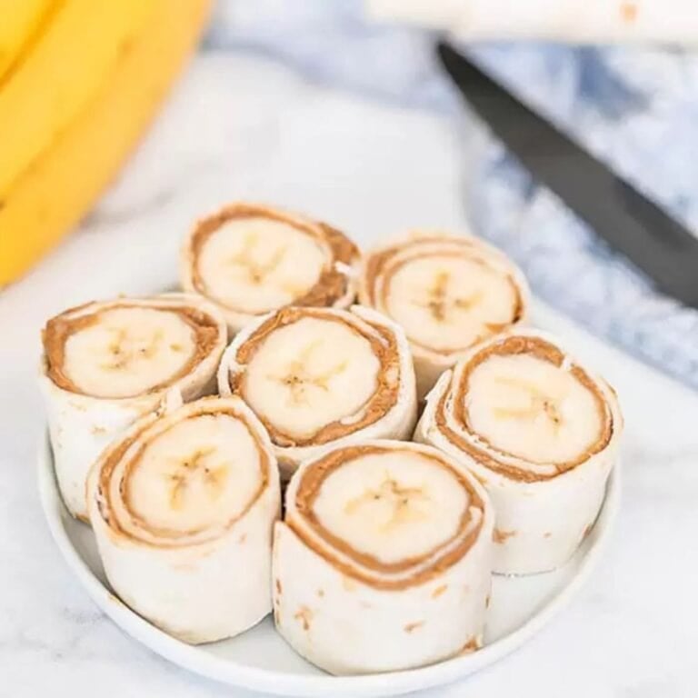 Banana peanut butter rollups on a plate.