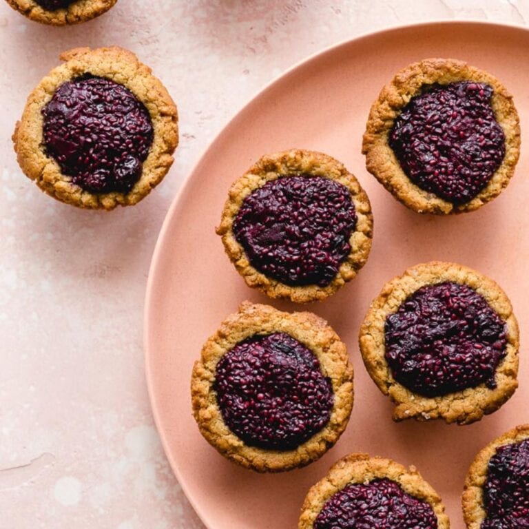 Peanut butter and jam cookies on a plate.