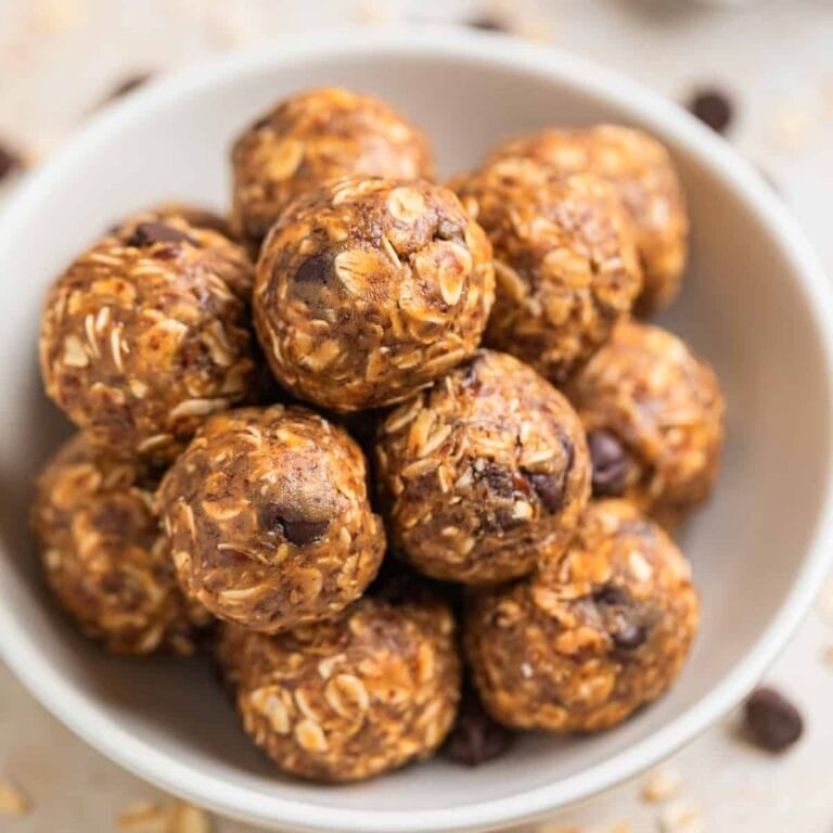 White bowl full of peanut butter oatmeal balls.