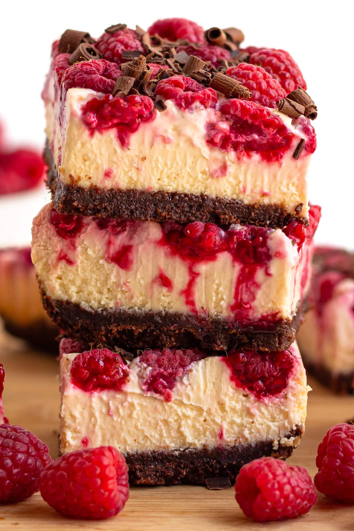 Stack of raspberry cheesecake bars.