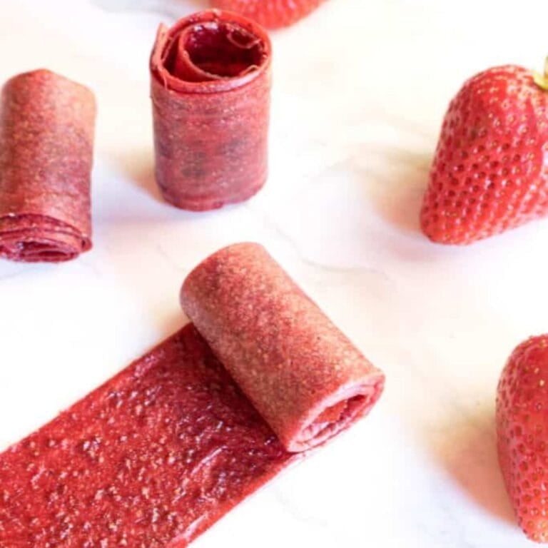 Homemade strawberry fruit rollups on a white background.