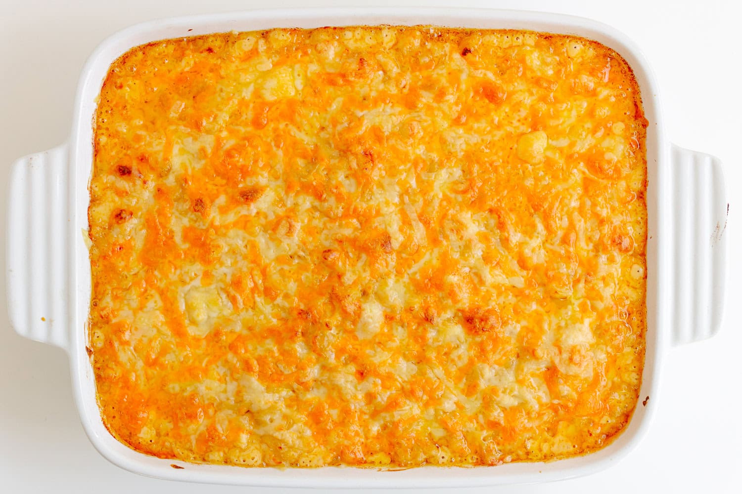 Baked three cheese mac and cheese in a white casserole dish.