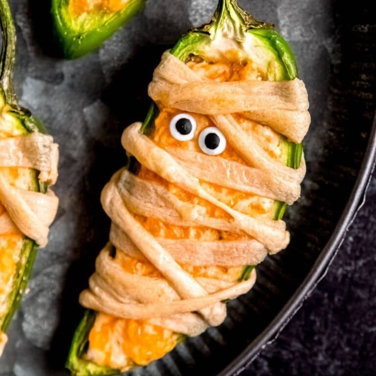 Jalapeno popper decorated like a mummy.
