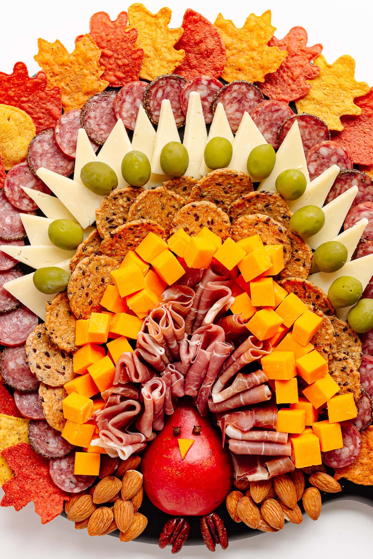 A Thanksgiving charcuterie board arranged in the shape of a turkey.